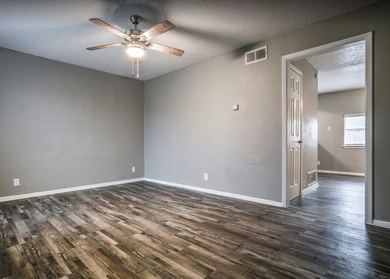 Living room with wood look flooring and ceiling fan